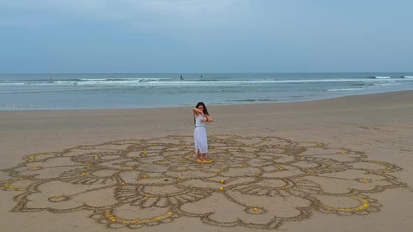 Woman Drawing the Big Mandala at Sand and Dancing in Empty Beach Top View Above From Drone