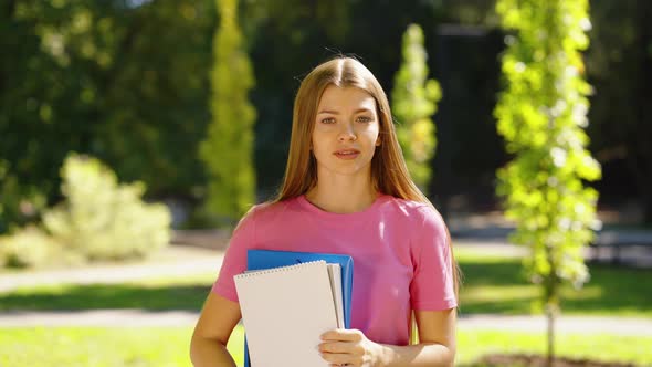 Student with Books in Sunny Park