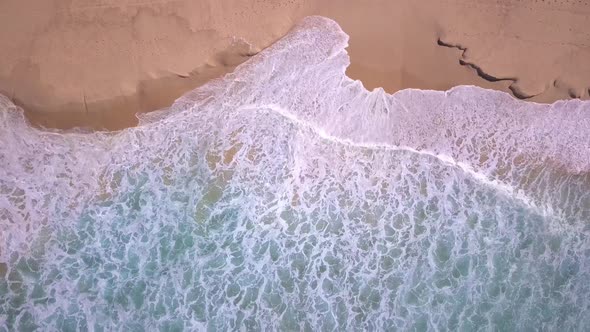 Beautiful top aerial view of beach with turquoise ocean water and sea waves reaching shore. Sydney,