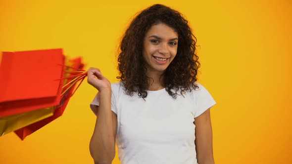 Happy Afro-American Woman Holding Shopping Bags and Showing Ok Gesture, Sale