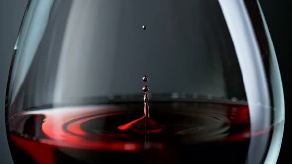 Super Slow Motion Macro Shot of Wine Drop Falling Into Red Wine in Glass at 1000Fps