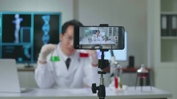 Asian Scientist Man Using Smartphone Recording Video While Researching In The Laboratory