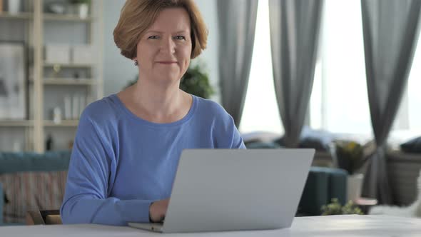 Old Woman Accepting Offer by Shaking Head at Work