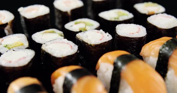 Various sushi on black background