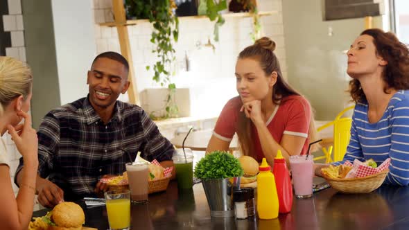 Executives interacting while having lunch at table 4k