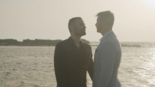 Gay couple on the beach together during sunset