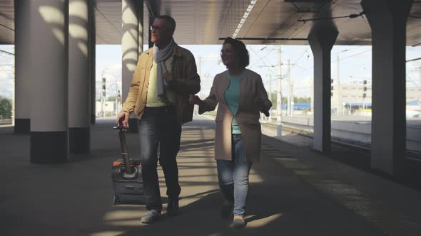 Mature Couple at Railway Station Waiting for Train and Dancing