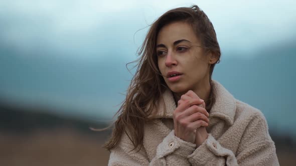 Slow Motion Close Up Face of Disappointed Ukrainian Woman Stands Outdoors at Cold Cloudy Autumn Day