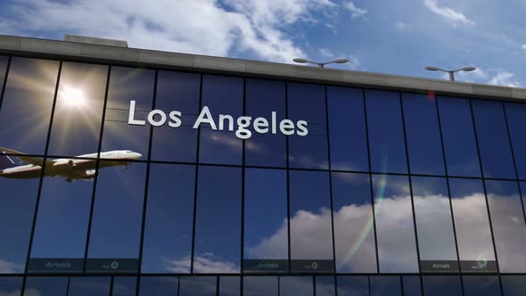 Airplane landing at Los Angeles mirrored in terminal