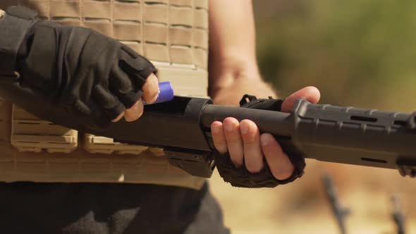 Man Charging Rounds in Airsoft Shotgun Outdoors