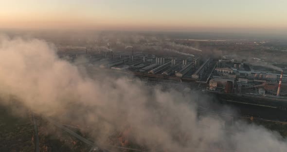 Drone Flying Over Smoking Chimneys of a Steel Factory. Aerial Top View of Metallurgical Plant