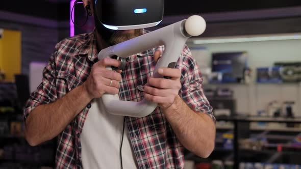 Man Use a Virtual Reality Headset with Glasses and Hand Motion Controllers