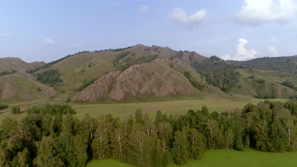 Flying over forest to Mountain in Siberia