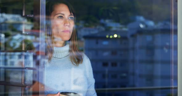 Woman Standing with Coffee Cup Near Window 4k