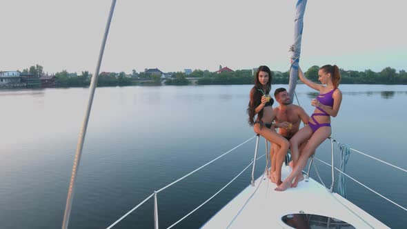 Guy with  Girls Resting on the Yacht