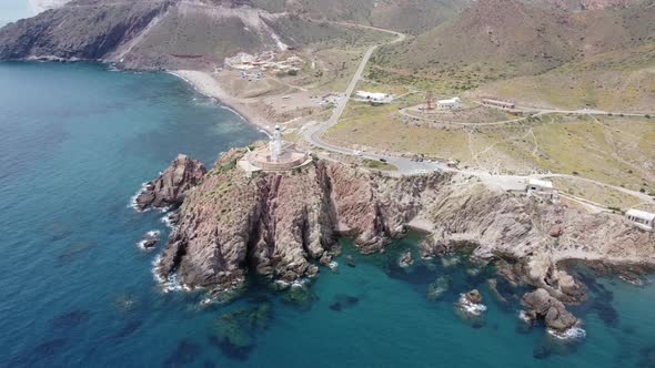 flying around a lighthouse on a cliff from a high viewpoint