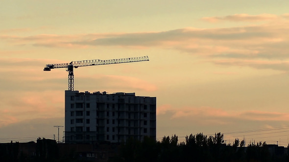 Silhouette Of  Crane Working At Sunset