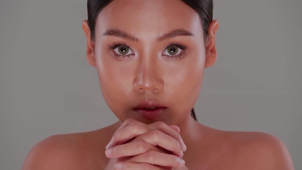 Portrait of Asian young woman with soft make-up and tanned skin.