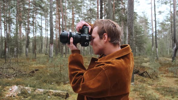 A Young Blond Male Photographer Takes Pictures of Nature