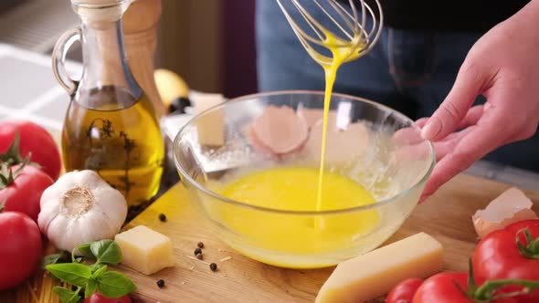 Making Pasta Carbonara  Mixing Egg Yolks in Glass Bowl By a Whisk