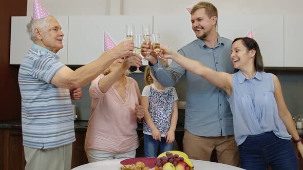 Multigenerational Family Members with Child Girl Kid Celebrating Birthday Party. Drinking Champagne