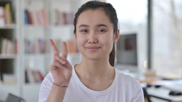 Portrait of Victory Sign By Approving Young Asian Woman 