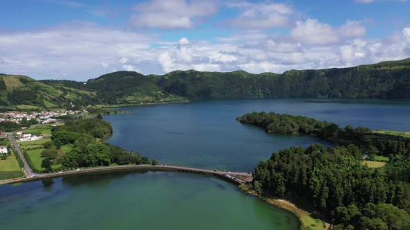 Volcanic crater with blue lake inside. Aerial drone top down flight over, Azores, 4k.