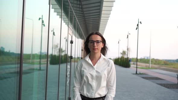 Portrait of Young Woman in White Formal Shirt and Glasses.