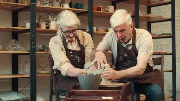 Cheerful Seniors Woman and Man are Engaged in Pottery Making Sculpture