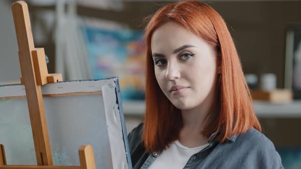 Caucasian Woman Artist Girl Painter with Red Hair Enjoying Art Work with Paints Creates Picture