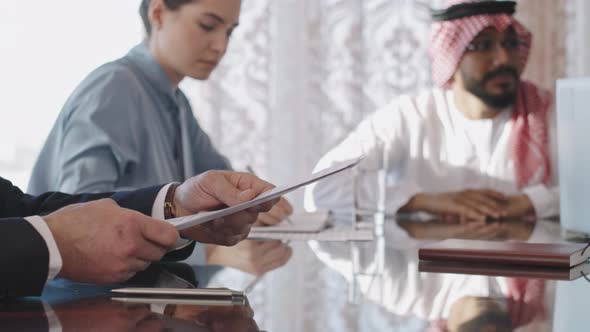 Multi-Ethnic Business Team Negotiating At Conference Table