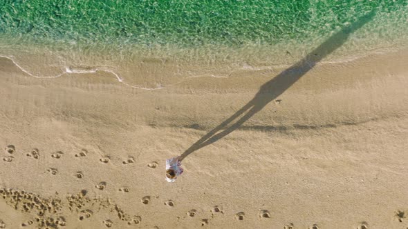 Aerial Overhead Shot Alone Woman Walking By Empty Sandy Beach Hawaii Nature