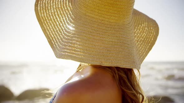 Woman standing on the beach 4k