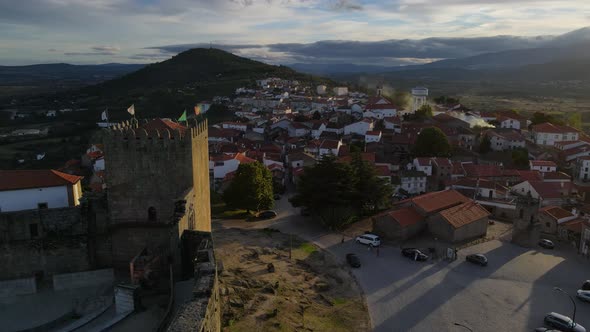 A drone flies past the tower of Belmont Castle over the roofs of the ancient town.