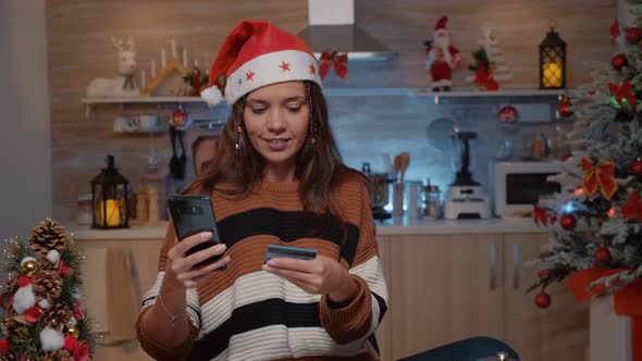 Festive Woman Using Smartphone for Shopping Presents