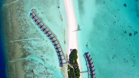 Aerial drone scenery of coastline beach time by lagoon with sand background