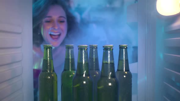 Young Caucasian Woman Open Fridge and Take Cool Beer Having Home Party