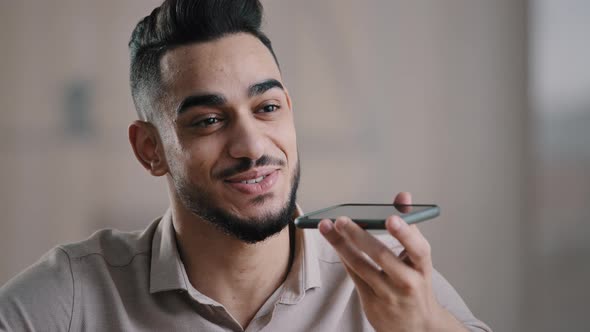 Happy Hispanic Man Guy Young Assistant Hold Cellphone Record Speech Audio Message on Mobile