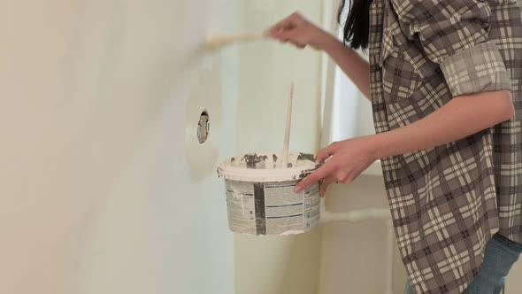 Female House Painters Paint the Walls in the Room.