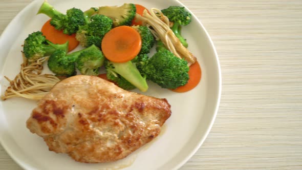 grilled chicken steak with vegetable on white plate