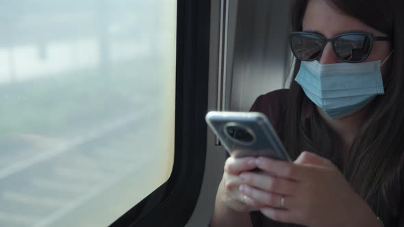 Woman using a phone on the train