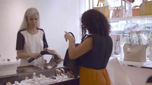 Latin Woman Buying Cloth in Fashion Store