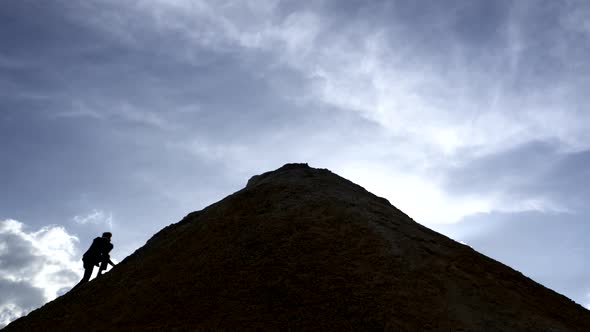 Silhouette of a Businessman Conquering the Top