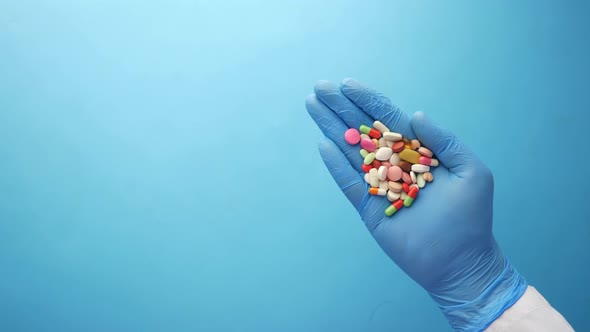 Doctor Holding Medical Pill on Palm of Hand