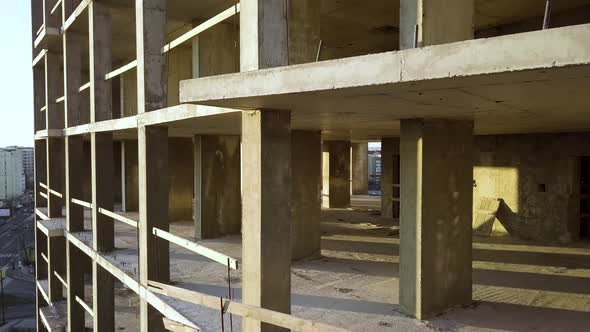 Concrete interior frame of tall apartment building under construction in a city
