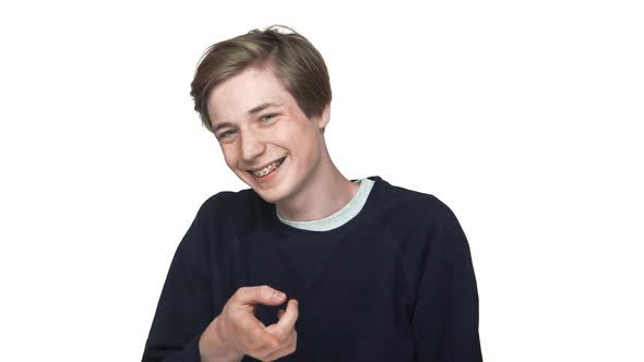 Portrait of Happy Smiling Teenage Boy in Braces Having Fun Mocking Someone Showing Index Finger