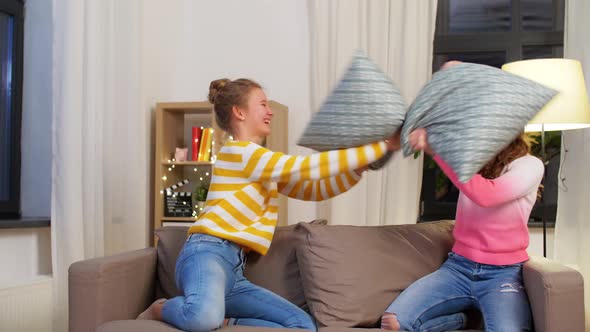 Happy Teenage Having Pillows Fight at Home