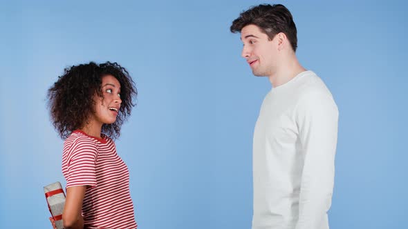 Young Interracial Couple on Blue Studio Background