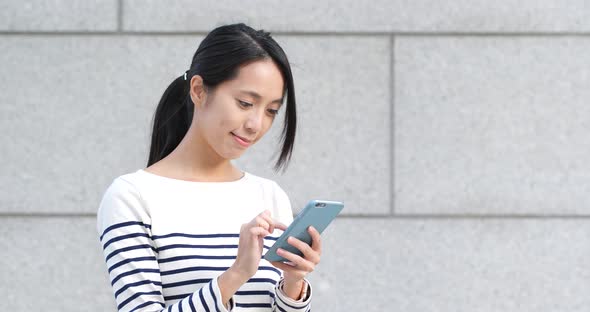 Woman use of mobile phone at outdoor