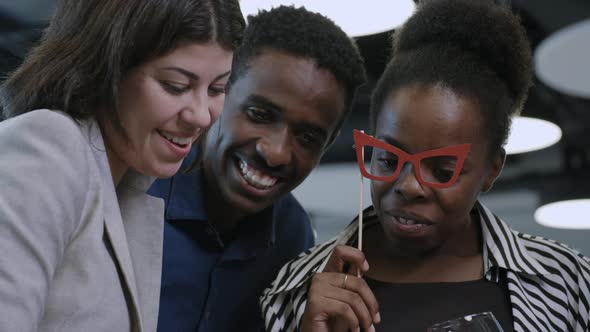 Cheerful Coworkers Taking Photos at Office Party